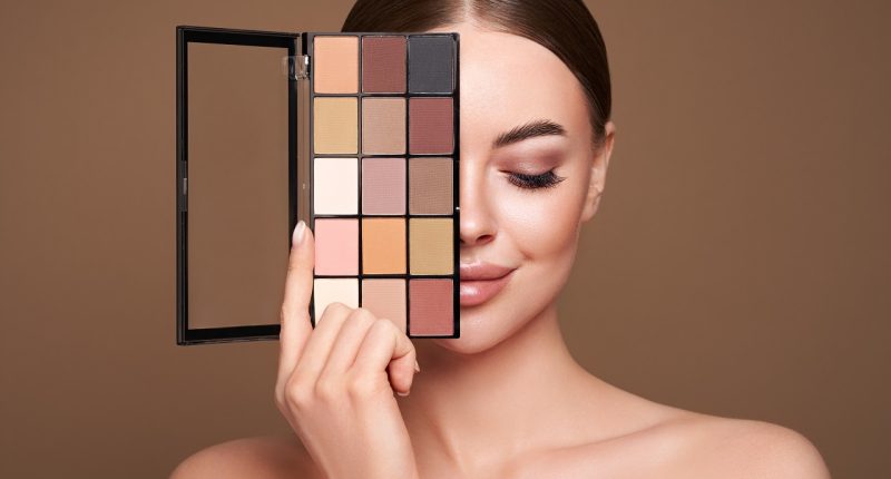 Beauty woman with eyeshadow makeup palette